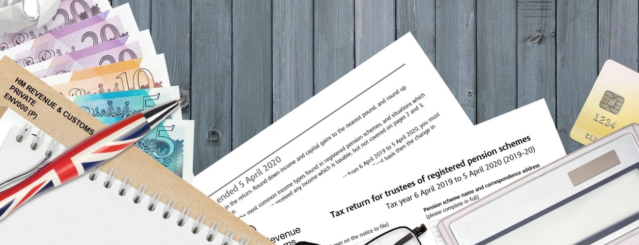 English Tax form sa970 Tax return for trustees of registered pension schemes from HM revenue and customs lies on table with office items. HMRC paperwork and tax paying process in United Kingdom